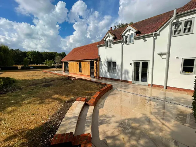 Finished patio and landscaping with curved seating wall