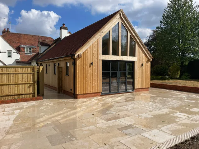 Finished oak framed kitchen extension with a glazed gable, seen from the side